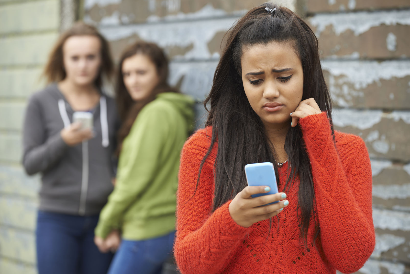 eenage girl being bullied by text message
