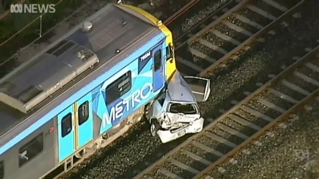 Two vehicles hit by Melbourne train after drivers exchange details on the track